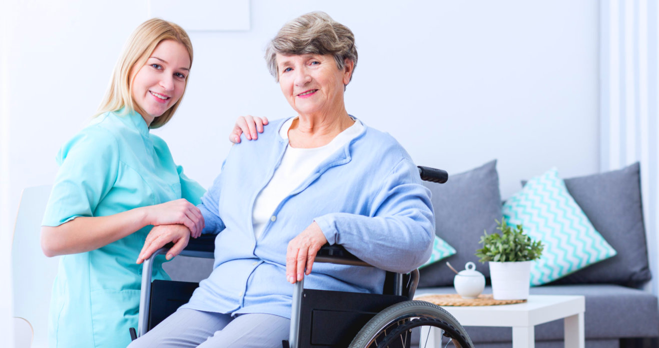 a caregiver and a senior woman smiling