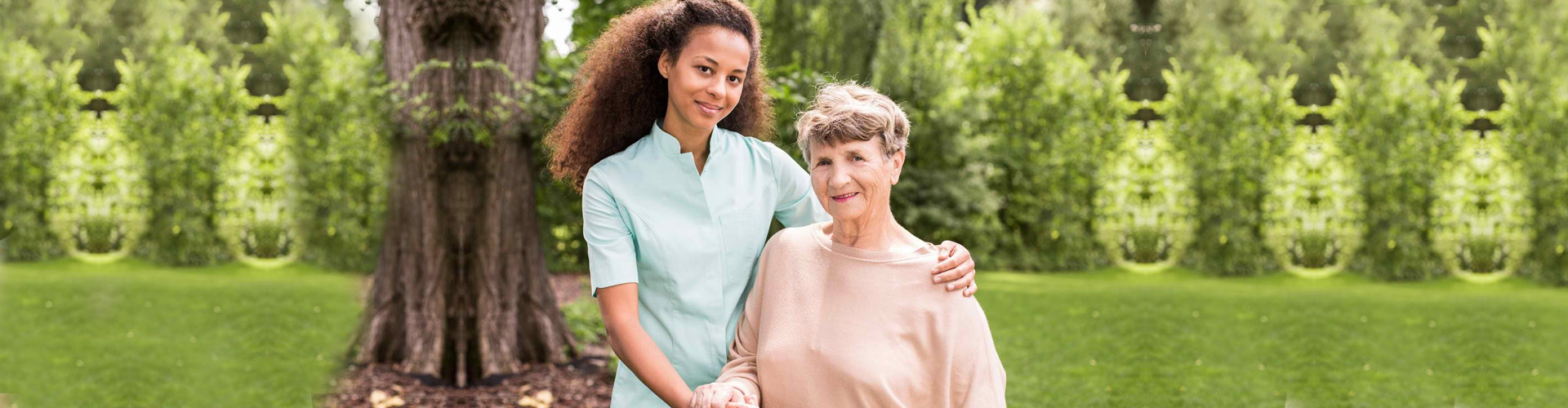 a caregiver assisting a senior woman walk